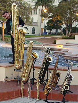 Jay C. Easton with saxophones: contrabass, bass, baritone, tenor, C tenor, alto, F mezzo-soprano, soprano, C soprano, sopranino